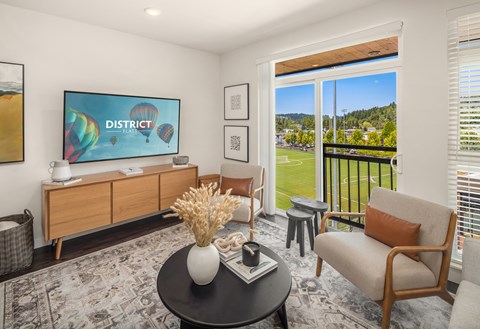 a living room with a table and chairs and a television